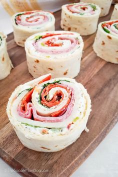 some food that is on top of a wooden cutting board and ready to be eaten