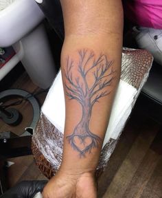 a person with a tree tattoo on their arm