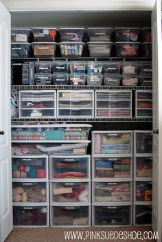 an organized closet with clear drawers and plastic bins