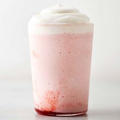 a pink drink with whipped cream on top