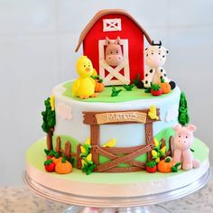 a cake decorated with farm animals and a barn