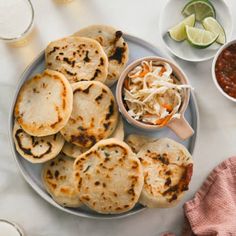 several flat breads on a plate with cole slaw