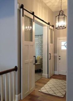 an entry way leading to a bedroom and another room in the house with white doors