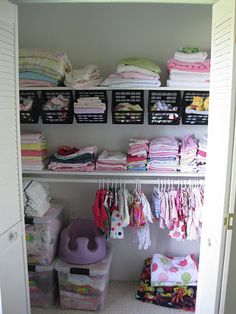 the closet is full of baby clothes and other things to put in it's bins