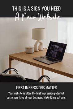 a laptop computer sitting on top of a wooden desk next to a lamp and chair