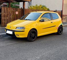 a yellow car parked in front of a house