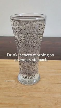 an empty glass sitting on top of a wooden table