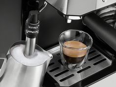 an espresso machine with a cup of coffee next to it