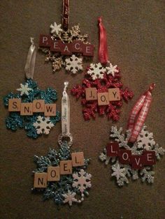 christmas ornaments made from scrabbles on the floor with words that spell out peace and joy