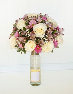 a vase filled with white and pink flowers