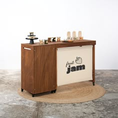 a small bar on wheels with an advertisement for jam in the front and two jars behind it