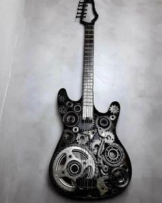 a black and white photo of an electric guitar with gears on it's body