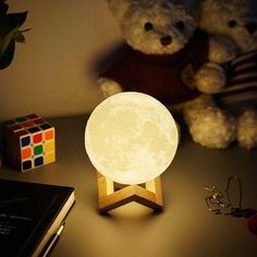 the moon lamp is next to a teddy bear