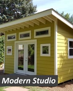 a small yellow house with the words modern studio on it