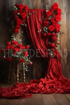 red roses and greenery are arranged in the shape of a letter