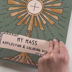 a person holding up a piece of paper that says, my mass reflection & coloring book