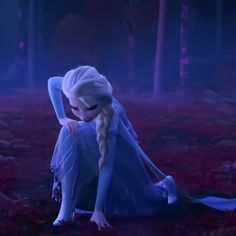 a frozen princess sitting on the ground with her hands behind her head and looking down