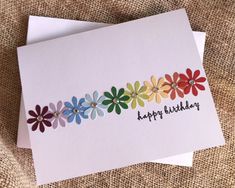 a birthday card with colorful flowers on it