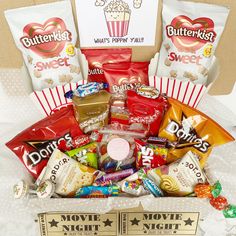 a box filled with candy and snacks on top of a table