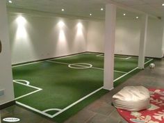 an indoor soccer field is painted green and white