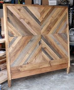 a bed frame made out of wooden boards in a room with other woodworking tools