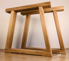 two wooden tables sitting side by side on top of a hard wood floored floor