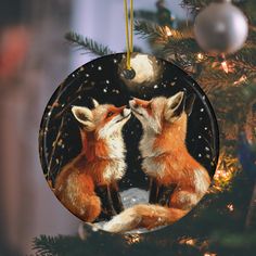 a christmas ornament with two foxes kissing