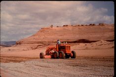 a tractor is driving through the desert