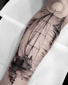 a man's arm with a sailboat on it