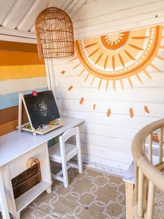 a white desk with a blackboard on it next to a wicker basket and lamp