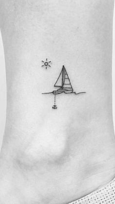 a small sailboat tattoo on the ankle