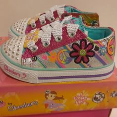 the children's shoes are decorated with colorful flowers