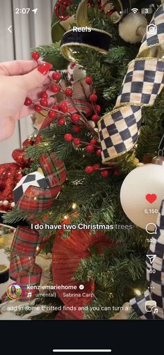 someone decorating a christmas tree with ornaments