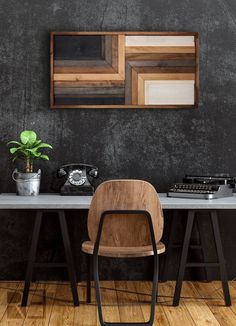 a chair sitting in front of a table with a phone on top of it next to a potted plant