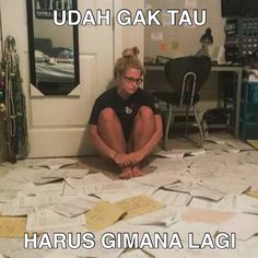 a woman sitting on the floor in front of piles of papers with words above her