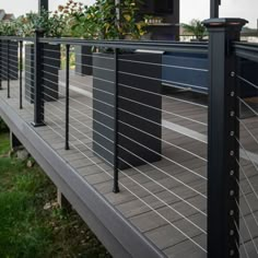 a black and white metal fence on top of a wooden deck