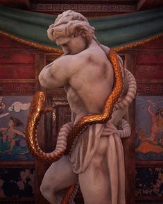 a statue with a snake wrapped around it's neck