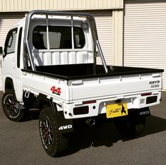 a white truck parked in front of a building