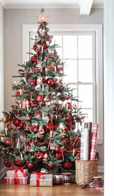 a christmas tree decorated with red and silver ornaments