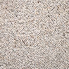 a close up view of a wall made out of rocks and pebbles, with no one on it