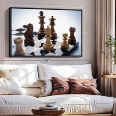 a living room with a couch, coffee table and chess board on the wall above it