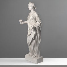 a statue of a woman holding something in her hand