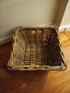 a wicker basket is sitting on the floor