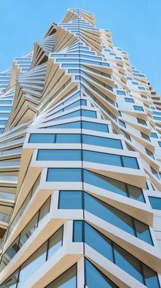 an upward view of a tall building with many windows