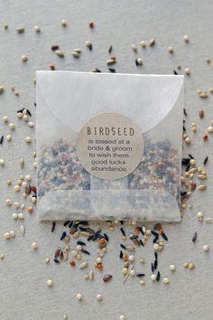 seed packet with bird seed seeds scattered around it