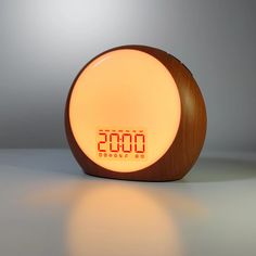 an alarm clock with the time displayed on it's face and in front of a gray background