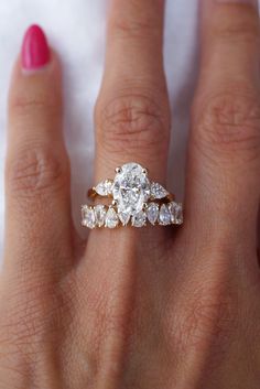 a woman's hand with a diamond ring on it