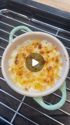 a casserole sitting on top of an oven rack with a video playing below it