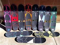 there are many skateboards lined up on the sidewalk