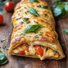 a cheesy vegetable enchilada on a cutting board with tomatoes and basil